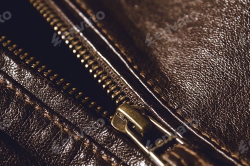 Preview: Brown leather texture and metal zipper . Fragment of leather jacket