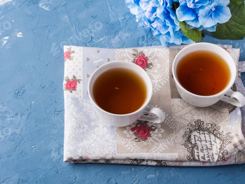 Preview: Cup of tea on blue background with flowers
