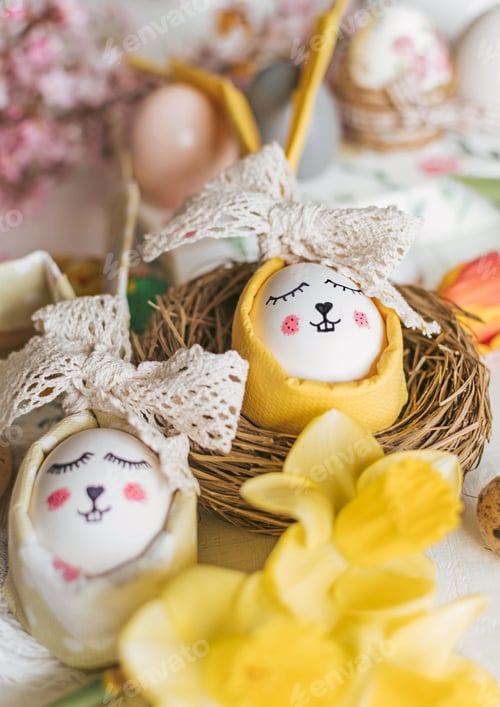 Preview: Close-up of Easter holiday decorations, food, eggs on white wooden background. Flowers, bunny, nest.