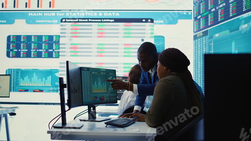 Preview: Financial analyst works on resource allocation plans with his staff