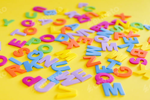 Preview: Back to school concept. Detailed plastic letters on yellow background