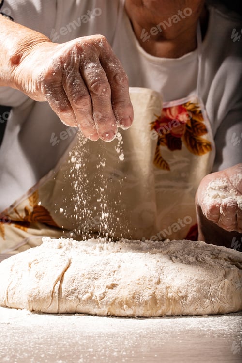 Preview: Hands of granny kneads dough. 80 years old woman hands kneading dough