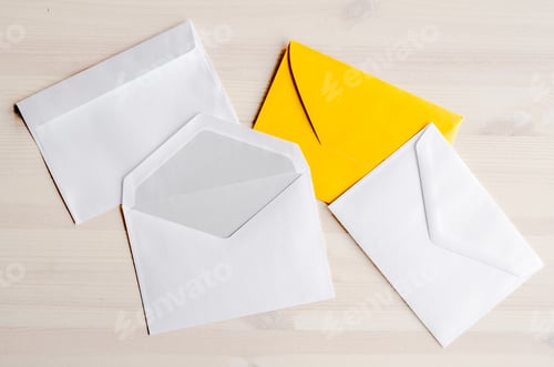 Preview: Three envelopes lying on wooden table
