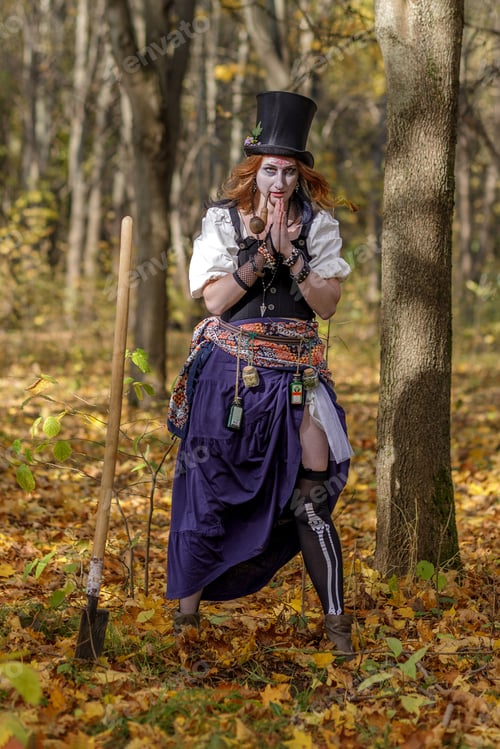 Preview: Portrait of young woman in Halloween carnival costume in autumn park.