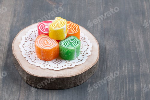 Preview: Colorful marmalade candies on wooden piece