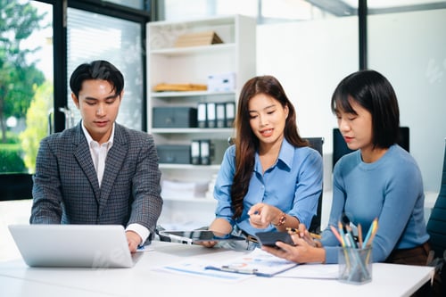 Preview: Asian business professionals discussing strategy and teamwork in office, showing
