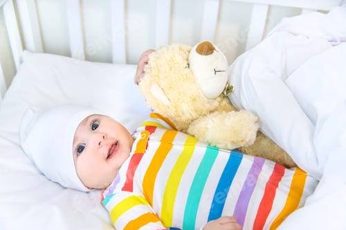 Preview: The baby in the crib goes to bed. Selective focus.