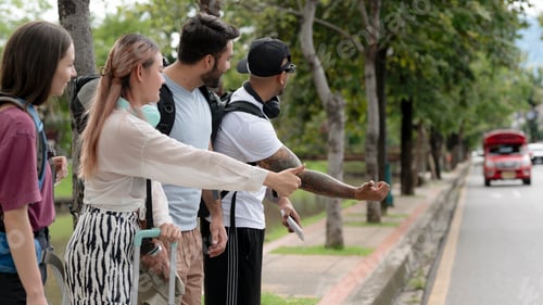 Preview: Foreign tourists hitchhike in Chiang Mai in Thailand.