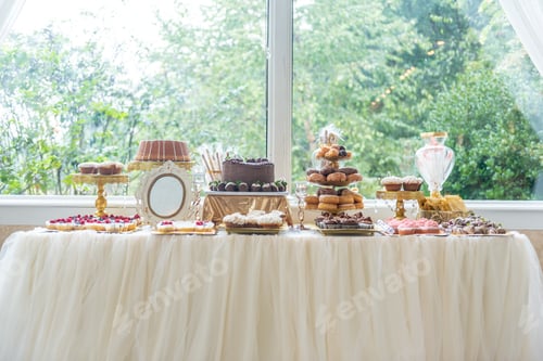 Preview: Delicious cakes, cupcakes, and sweets on a table near a big window