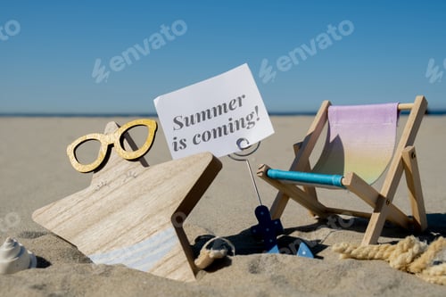 Preview: SUMMER IS COMING text on paper greeting card on background of beach chair lounge starfish summer