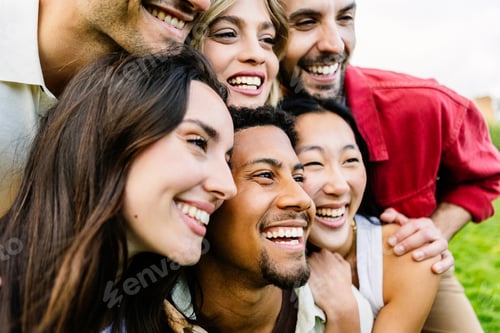 Preview: Portrait of happy young people standing together outside