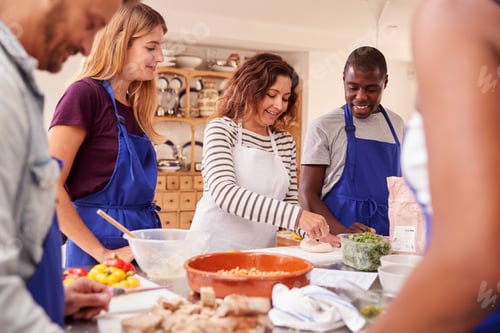 Preview: Female Teacher Demonstrating How To Use Dough To Make Flatbread In Cookery Class