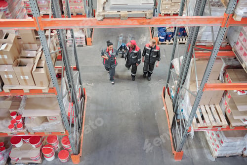 Preview: Two young intercultural male workers of warehouse talking to head manager