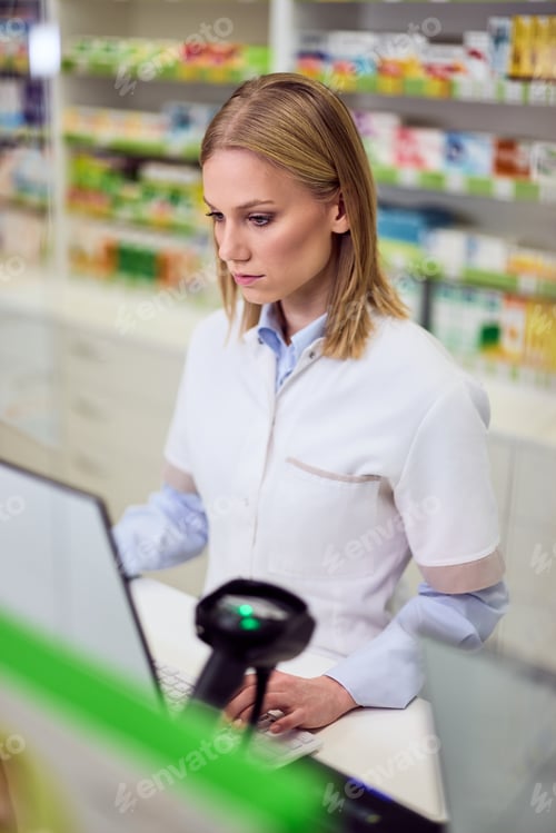 Preview: Professional Pharmacist at Counter in a Modern Pharmacy Checking Patient Records