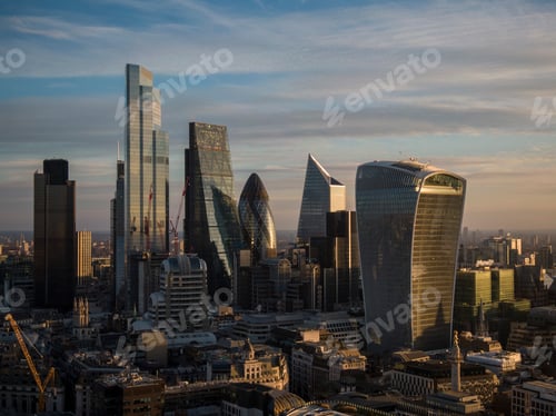Preview: UK, London, Aerial view of financial district skyscrapers at sunset