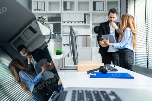 Preview: Diverse businessman and woman working and collaborating in modern office.