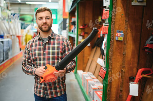 Preview: a young man in a gardening equipment store