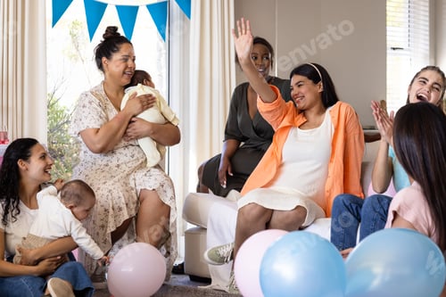 Preview: Women celebrating baby shower with balloons, smiling and enjoying moment together
