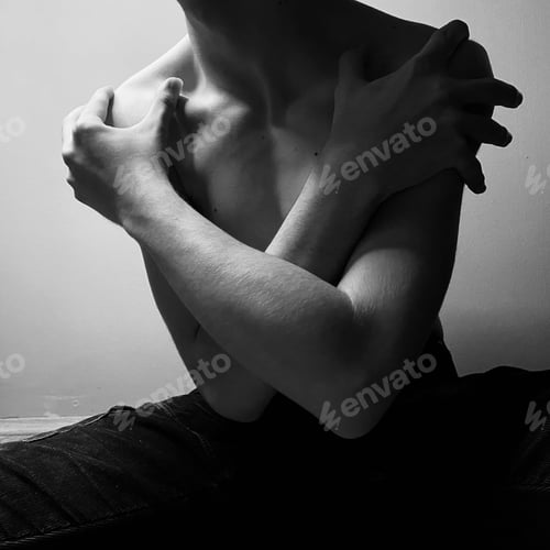 Preview: Young adult male sitting in a relaxed position, with his arms draped over his shoulder