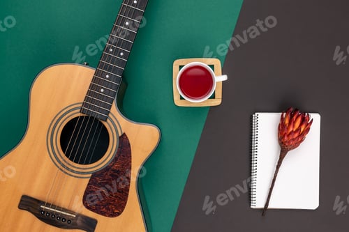 Preview: Flat lay, acoustic guitar and notebook on color background.