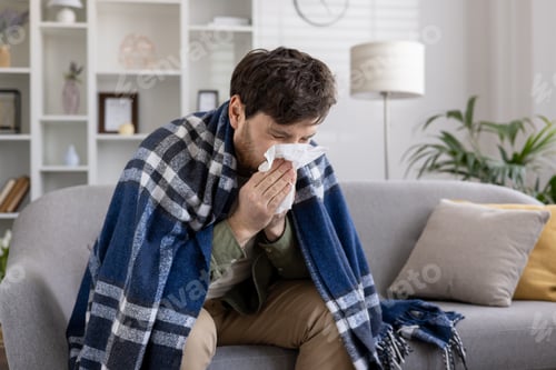 Preview: Man with Cold Wrapped in Blanket Indoors
