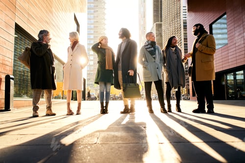 Preview: Silhouette of a group of business people full body talking outdoors in the city street