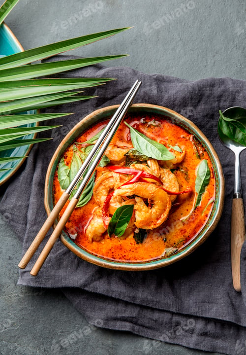 Preview: THAI SHRIMPS RED CURRY. Panaeng Curry in blue plate on gray background.