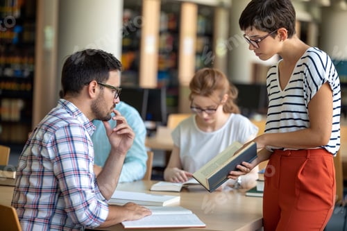 Preview: Happy group of students studying and working together in a college library