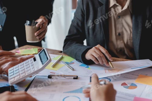 Preview: Business People Analyzing Financial Reports at a Table