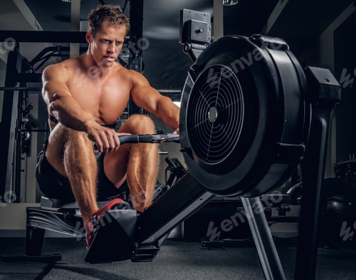 Preview: A man doing workouts on a back with power exercise machine.