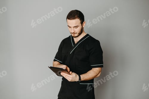 Preview: Portrait of a friendly doctor. Isolated on gray