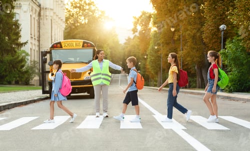 Preview: Group of children passing crosswalk on their way to school bus