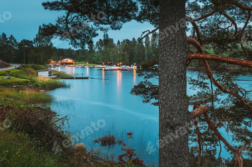 Preview: Sweden. Road To Beautiful Swedish Village near Lake. Wooden Log Cabin Houses In Summer Evening Night