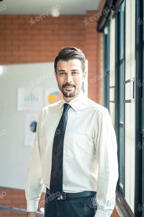 Preview: Caucasian businessman standing and smile in meeting room in modern company office.