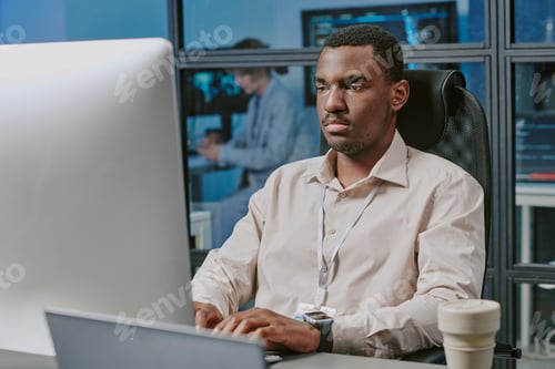 Preview: Serious Black Man Typing On Computer
