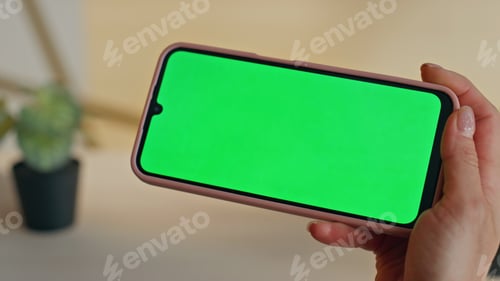 Preview: Lady watching greenscreen smartphone waiting online conference at table closeup
