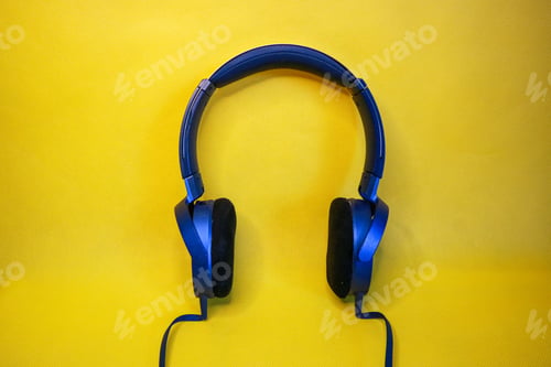 Preview: Blue headphones isolated on a yellow background