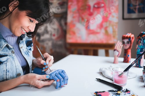 Preview: Young artist painting in art class at school studio. Creative people doing craft work