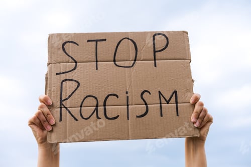 Preview: banner in hand stop racism against the sky