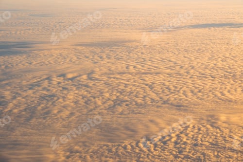 Preview: golden cloud over the blue sky Out side above view from airplane side windows