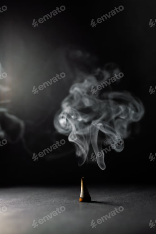 Preview: Beautiful shot of rising smoke in a dancing pattern on a dark background
