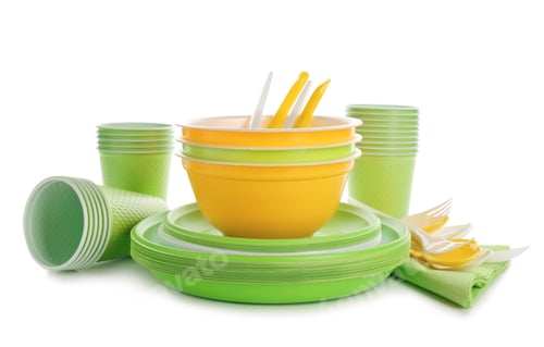 Preview: New plastic dishware and napkins on white background. Table setting