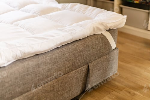 Preview: A person sleeps on the couch with a mattress topper set on the sofa.