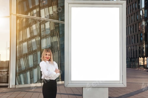 Preview: Smiling young woman businessman in white shirt presenting empty large banner