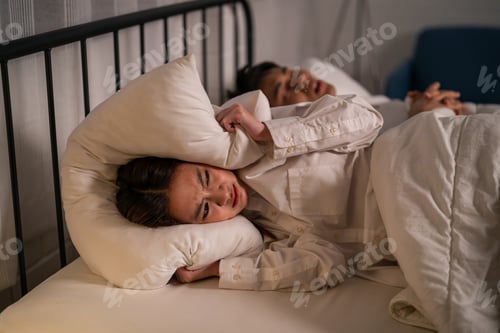 Preview: Asian woman feel frustrated from husband snoring while sleep at night.