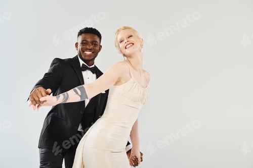 Preview: Elegance unveiled: bride in white, groom in tuxedo