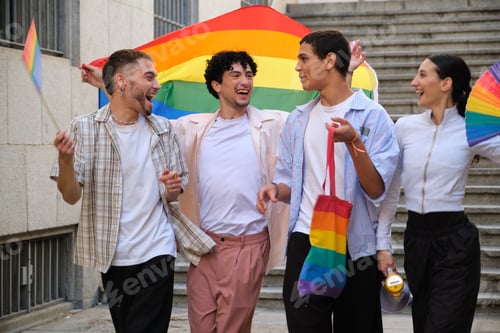 Preview: Diverse young people celebrating pride with rainbow flags