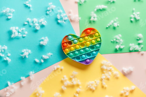 Preview: Silicone rainbow antistress toy in the shape of a heart on a cardboard of different colors