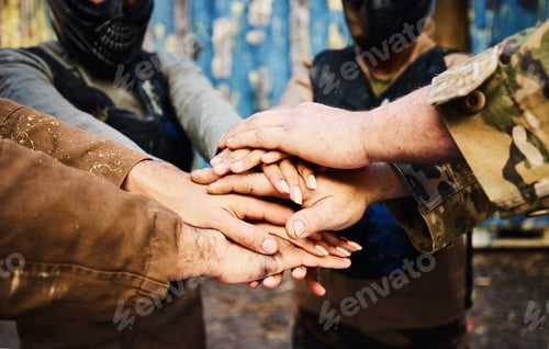 Preview: Motivation, team building or hands in huddle on a mission, strategy or soldier training on paintbal