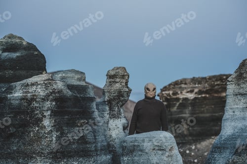 Preview: Standing alien mask people in moon style landscape. Concept of diversity and alien invasion